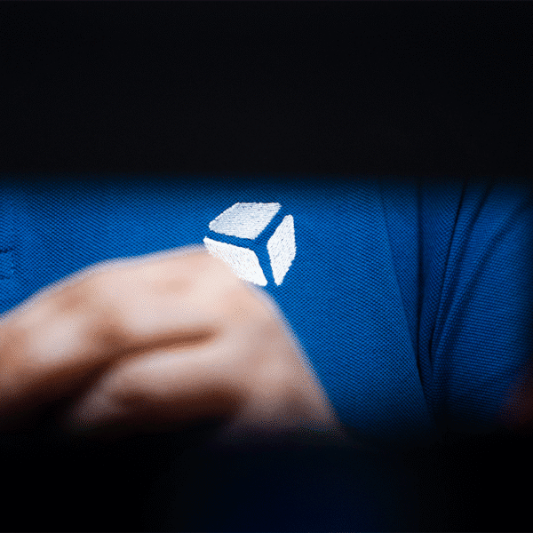 cube controls white logo, embroidered on a polo shirt. Ph. by Mario Puledda