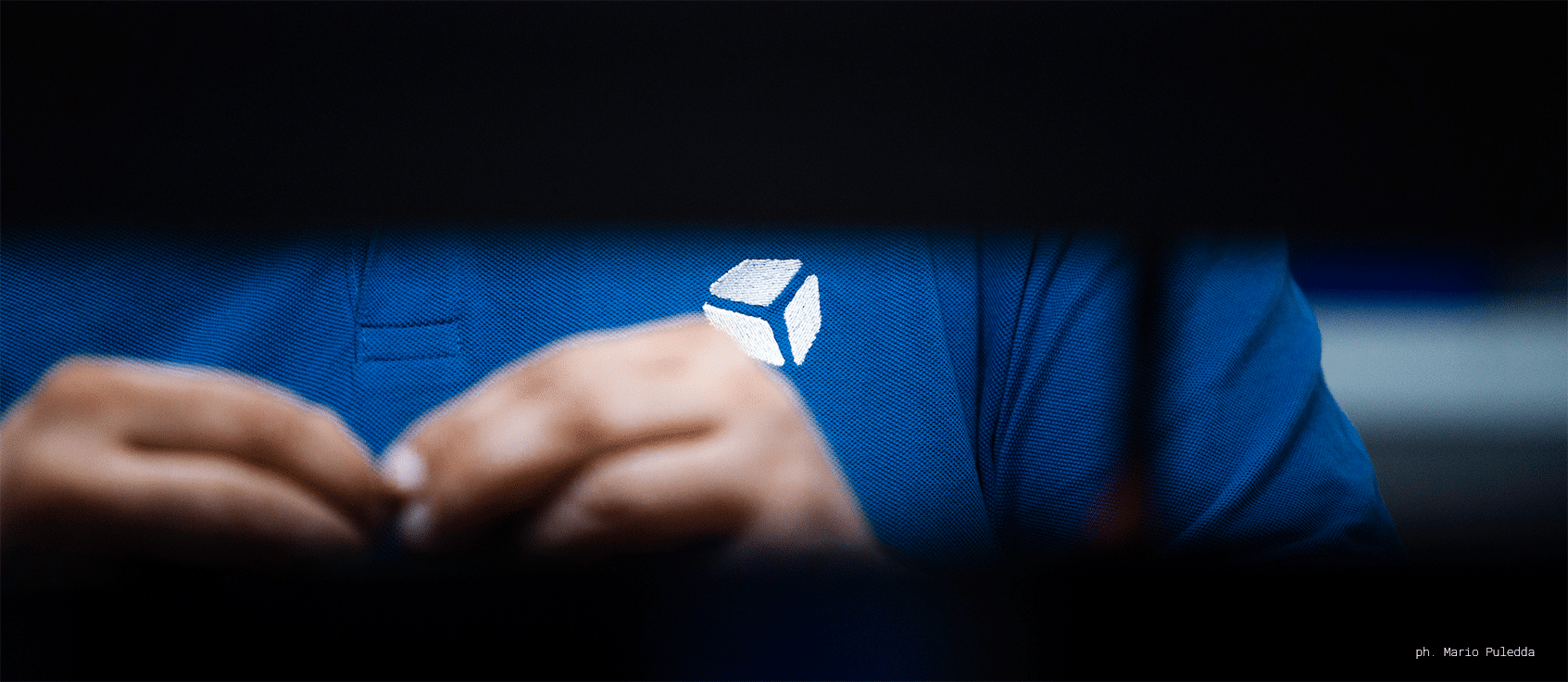 cube controls white logo, embroidered on a polo shirt. Ph. by Mario Puledda